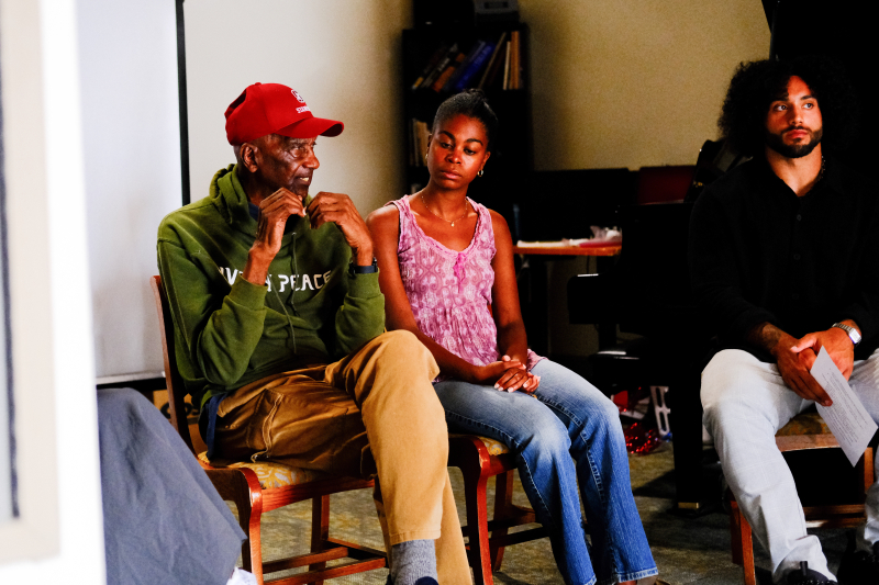 Bob Hoover (left) sits with two others at event.