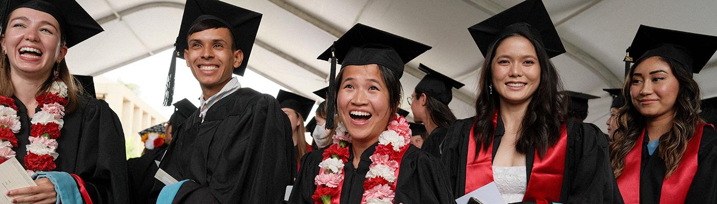 Stanford GSE Graduates smiling at commencement ceremony