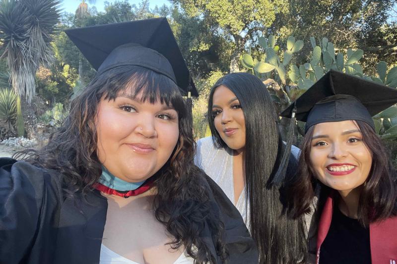 Photo of three STEP students in graduation caps and gowns