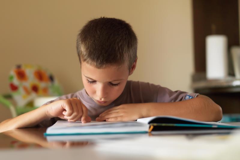 Photo of young boy reading