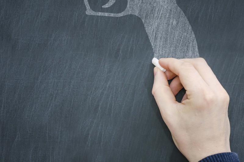 Illustration of a gun being drawn on a chalkboard