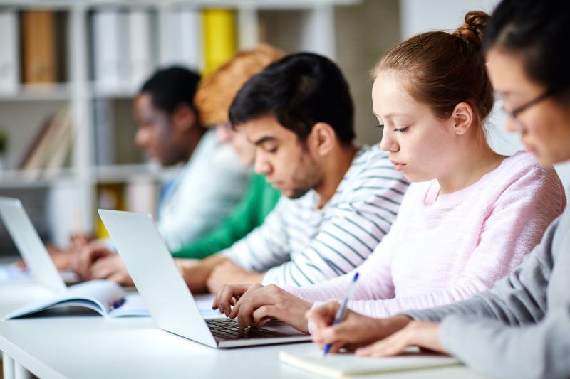 Photo of students in a classroom with laptops