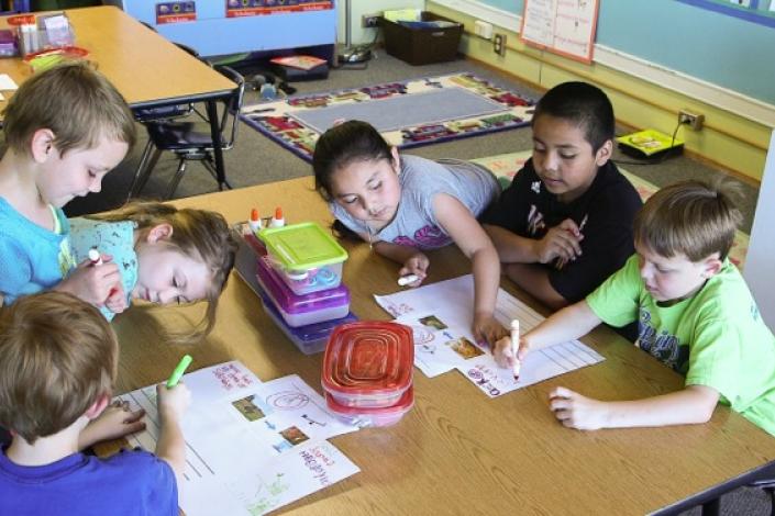 First graders in a dual language program in Corvallis, Ore. work on a poster project.