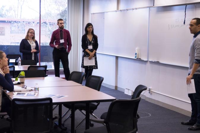 Master's students present their proposal to alumni panelists during the POLS Challenge. (Photo: Marc Franklin)
