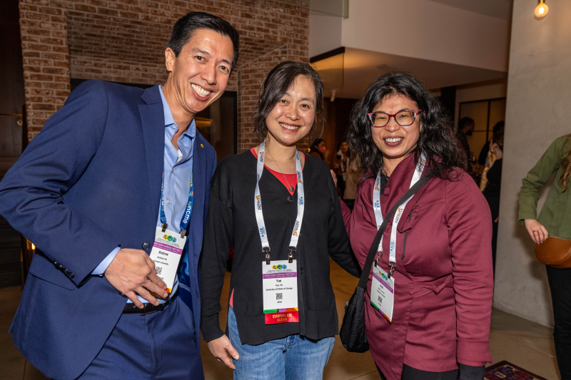 Three alumni standing together at AERA reception 2025