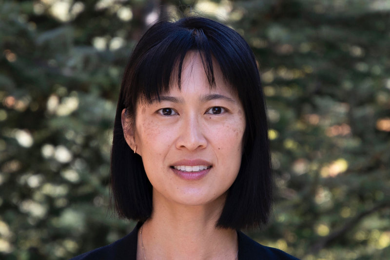 Woman in front of trees