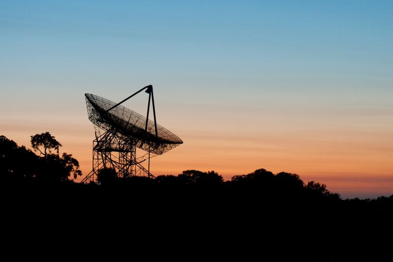 image of a land based satellite antenna at sunset
