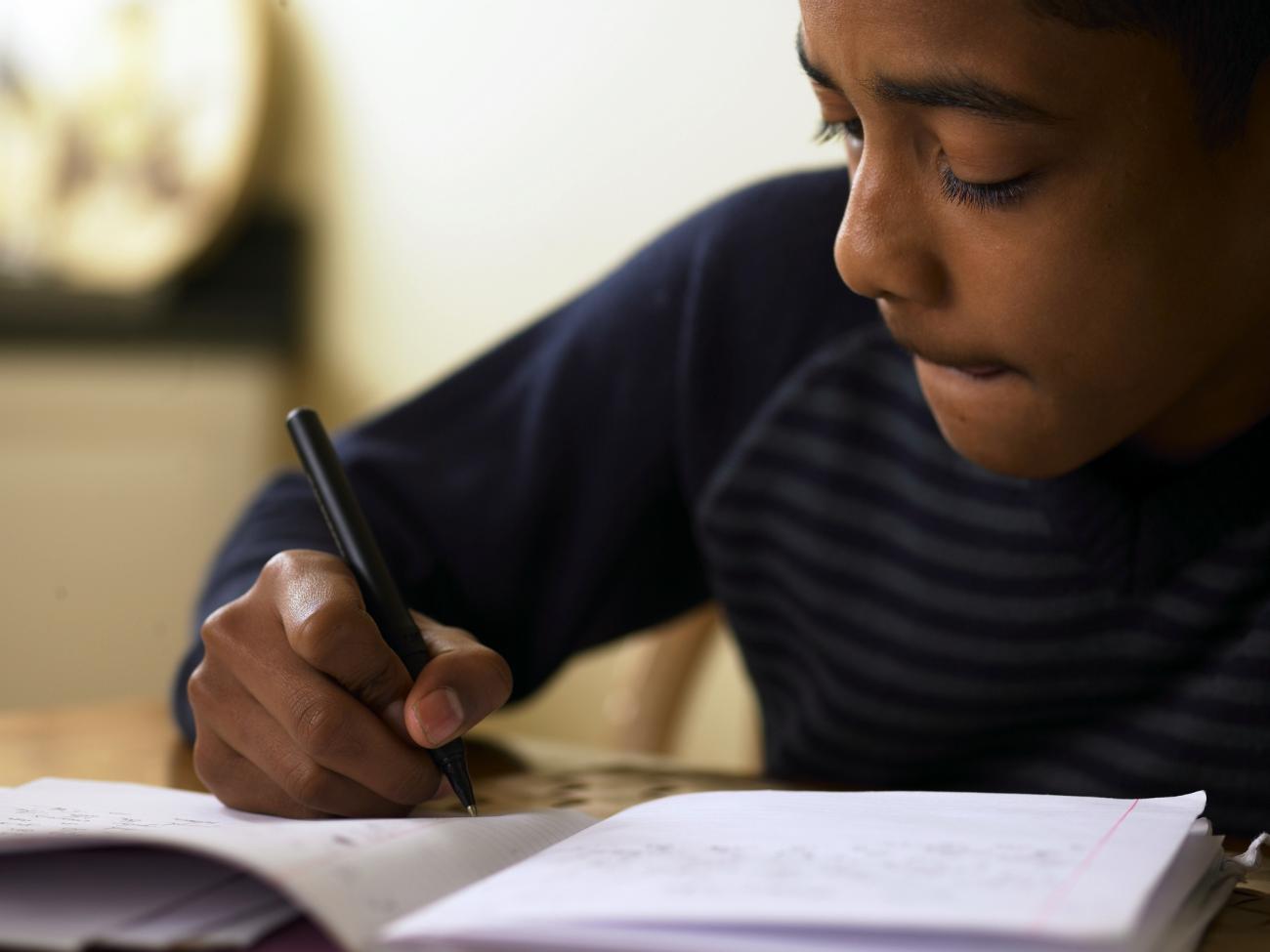 Photo of boy doing schoolwork at home
