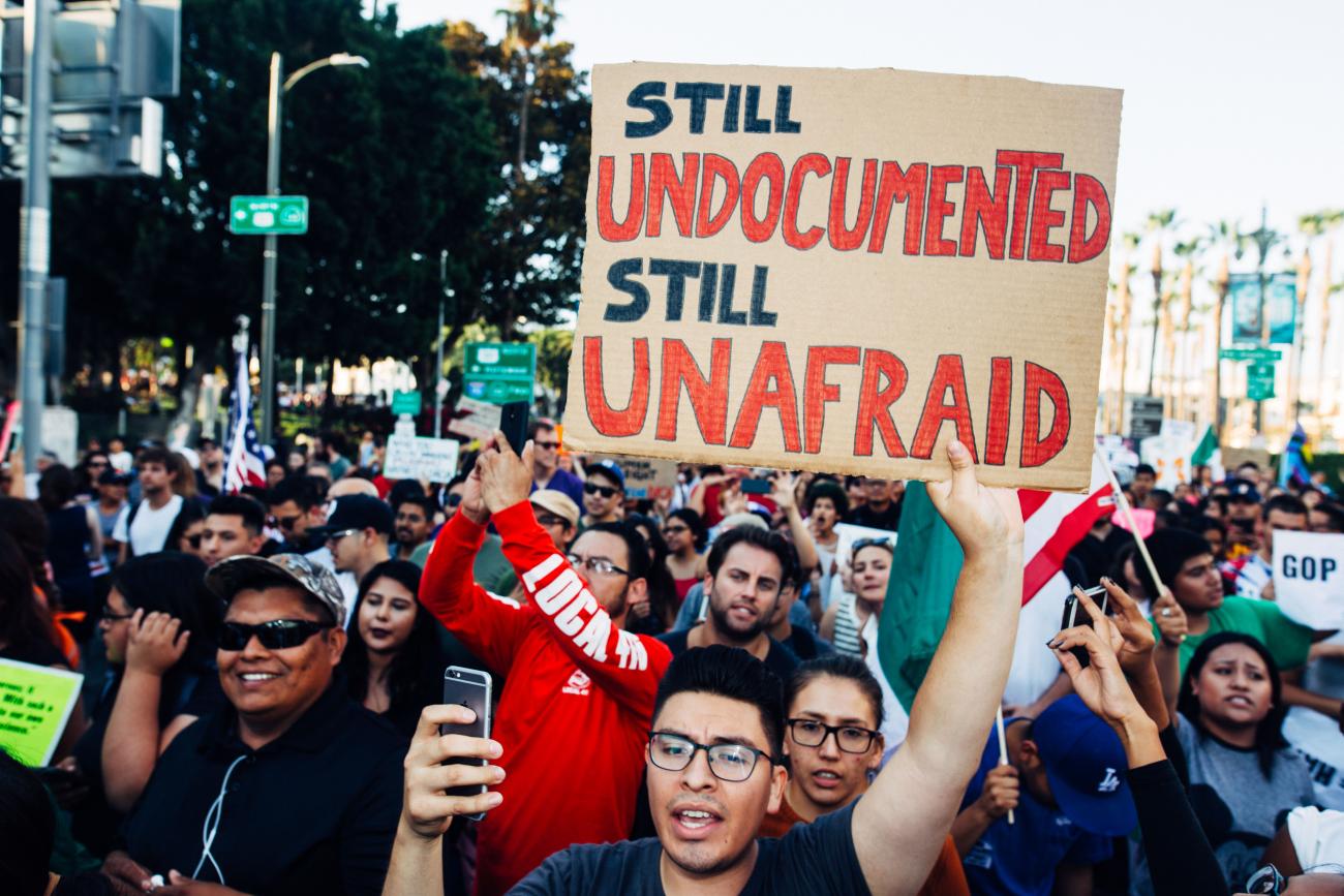 Photo of protesters with poster saying "Still Undocumented, Still Unafraid"